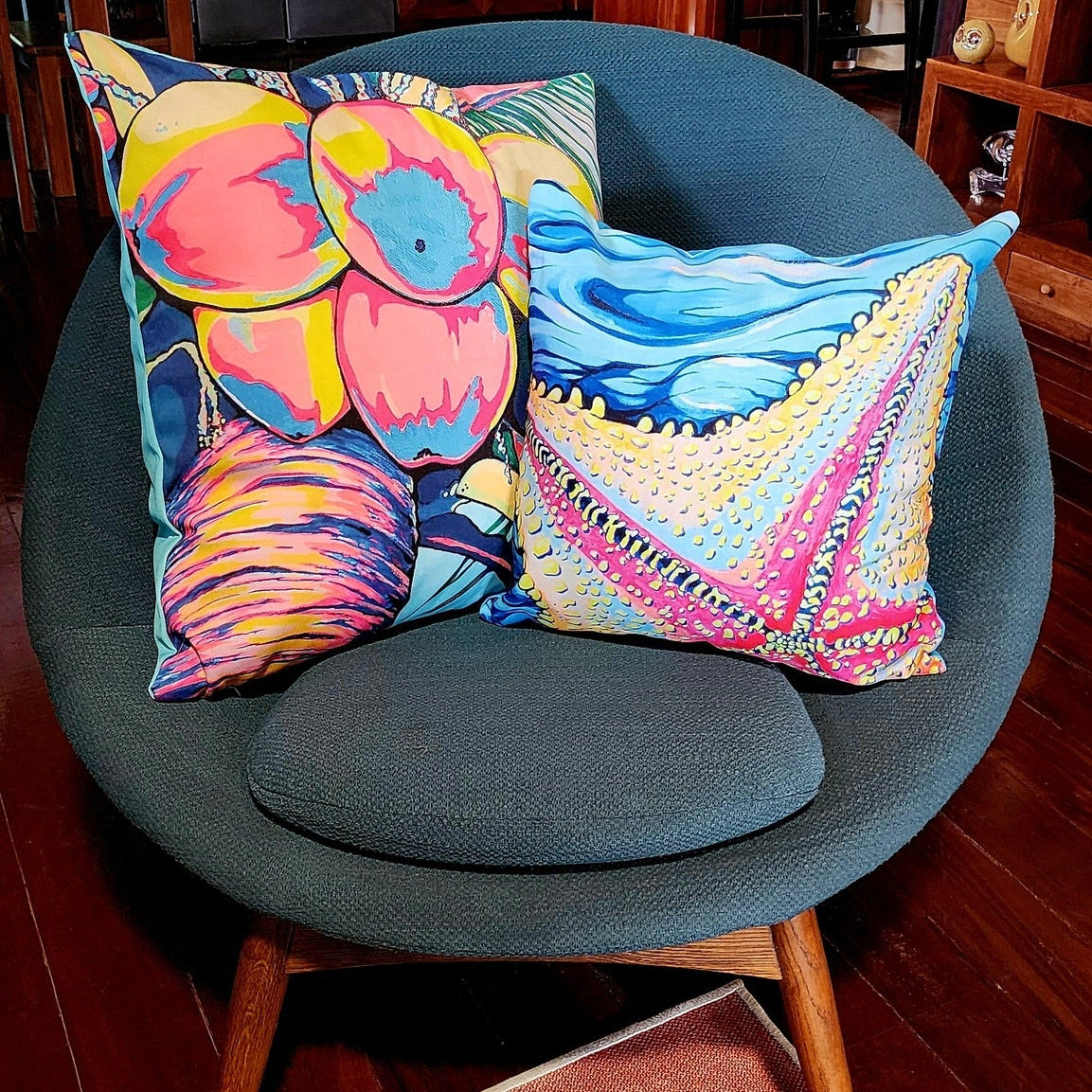 Colorful pillows on a gray chair in a kitchen setting